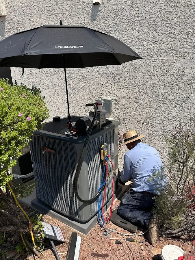 HVAC technician performing outdoor AC maintenance in Murray